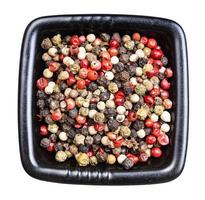 Pepper Blend peppercorns in black bowl isolated photo