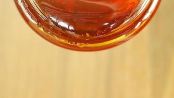 Close up shot of honey pouring out of glass jar. Health and beauty product sustainable lifestyle concept. video