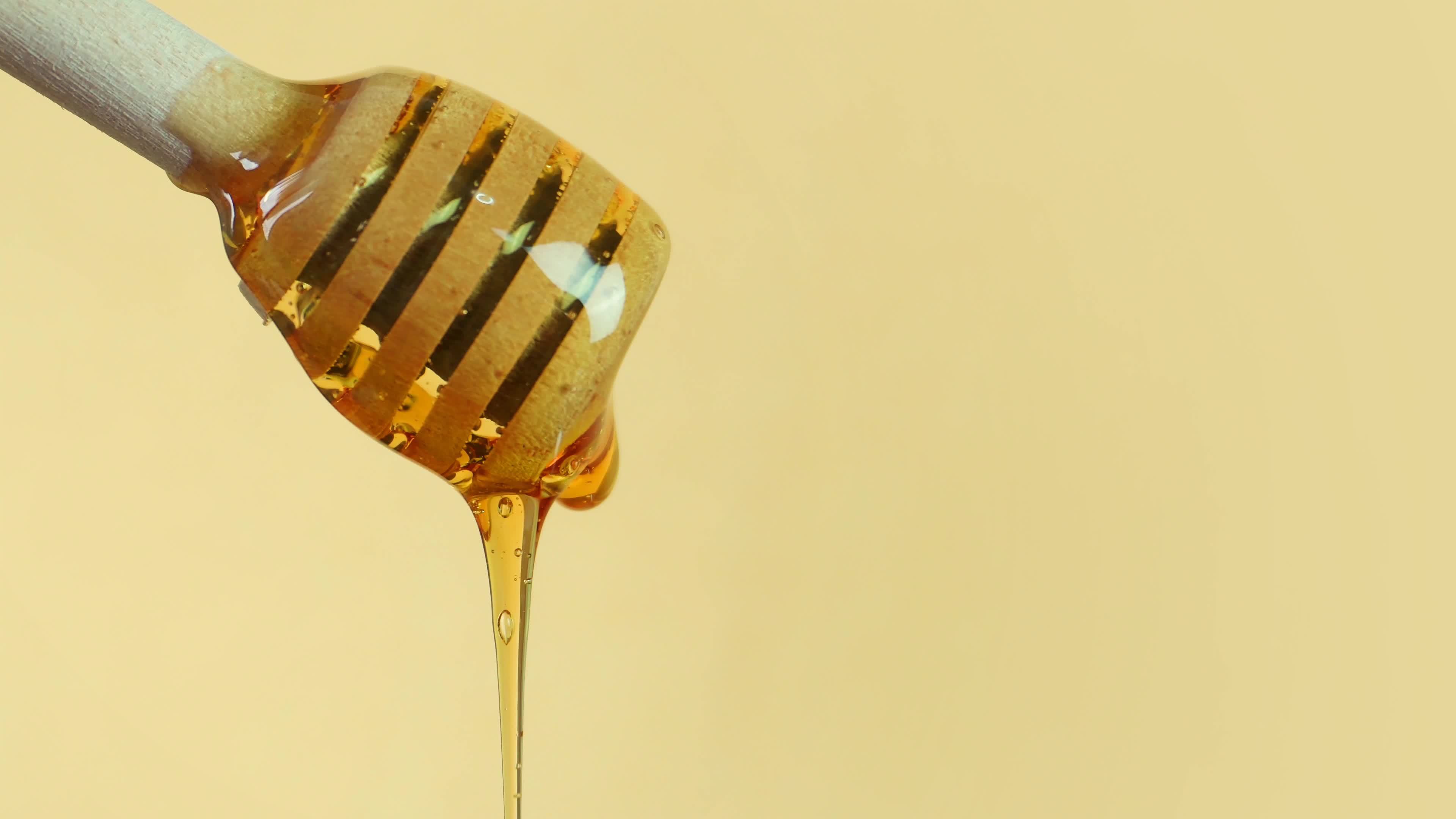 Honey dripping from a honey dipper. Healthy eating diet sustainable