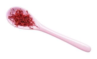 crocus saffron threads in ceramic spoon isolated photo