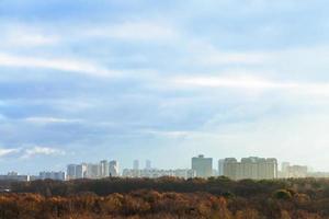 evening blue clouds over city in autumn photo