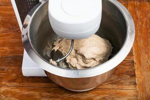 kitchen processor kneads ball of dough photo