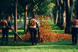 People operating a heavy duty leaf blower. photo