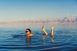 Girl is relaxing and swimming in the water photo