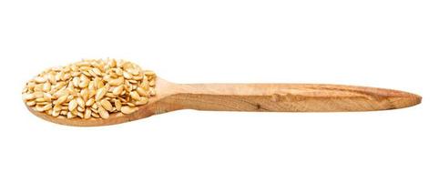 wooden spoon with golden flax seeds isolated photo