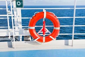 red life buoy on side of cruise liner photo