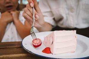 Fresh and sweet strawberry cake on white plate photo