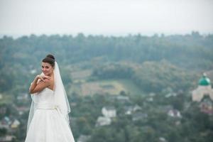 beautiful young bride poses for the camera photo