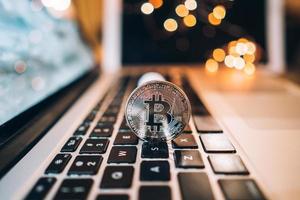 Macro shot of Bitcoins coins on laptop photo