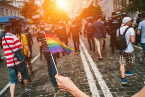 Hand hold a gay lgbt flag at LGBT gay pride parade festival photo