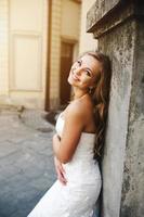 Beautiful bride posing against the backdrop of a European city photo