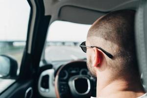 The man in the car traveling on the road photo