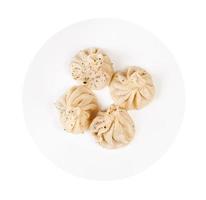 top view of peppered khinkali on plate isolated photo