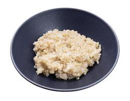 porridge from brown rice in gray bowl isolated photo