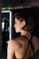 Portrait of Confident Brunette Woman Wearing Performance Wear in Gym photo