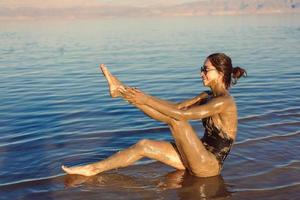 A young woman enjoying the natural mineral mud photo