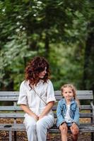 Lovely young mom and daughter in sunny day, happy family photo