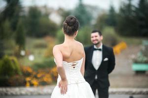 Beautiful wedding couple standing opposite each other photo