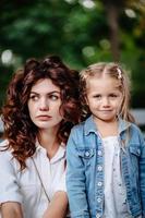 Lovely young mom and daughter in sunny day, happy family photo