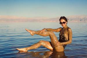 A young woman enjoying the natural mineral mud photo