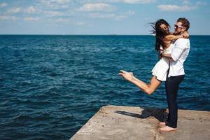 Guy and girl on the sea pier photo