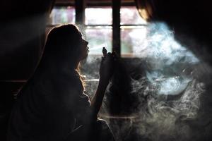 The girl smoke electronic cigarette photo