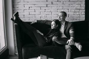 Happy couple sitting on a couch photo