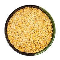 golden flax seeds in round bowl isolated photo