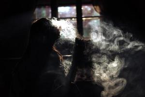 The girl smoke electronic cigarette photo