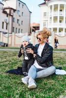 Young girl and child on green gras photo