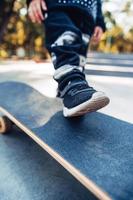 Boy legs on the skateboard close up image photo