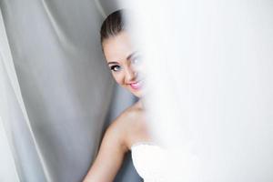 Beautiful bride posing in daylight photo