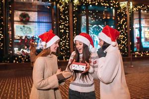 Portrait of happy cute young group of friends hugging each other photo