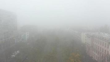 Foggy city street with silhouettes of residential buildings. photo