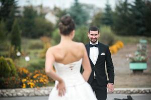 Beautiful wedding couple standing opposite each other photo