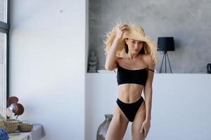 Woman In Bathroom. Fashion portrait model in a straw hat. photo