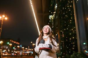 Night street portrait of young beautiful woman acting thrilled. photo