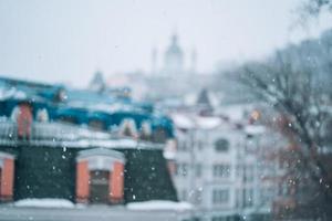 Copious snowfall over the city with the roofs photo