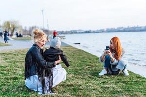 Two women and a little boy on the lake photo