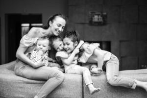 Mom, two daughters and a little son on the couch photo