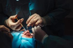 Cosmetic surgery on nose. Surgeon makes an injection photo