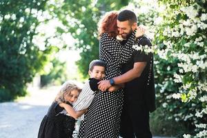 Mom, Dad, little son and daughter have fun photo