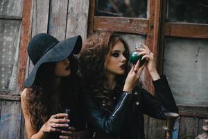 Two vintage witches perform magic ritual photo