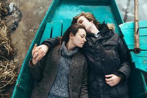 man and woman lie in the boat photo