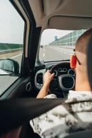 The man in the car traveling on the road photo