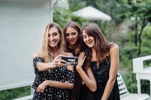 Three girls discuss photo