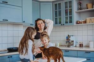 Happy family having fun in the kitchen photo