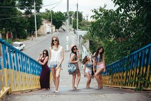 Five young beautiful girls in the city photo