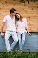 couple posing on a background of the wooden wall photo