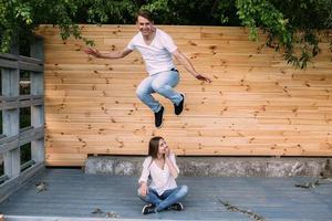 couple posing on a background of the wooden wall photo